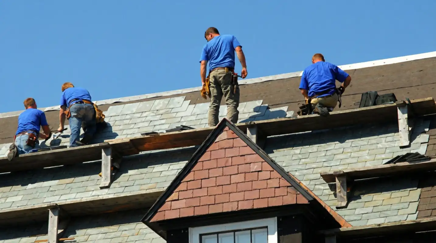 Roof replacement in progress with a team of professional contractors installing new shingles on a residential home in Wichita, KS