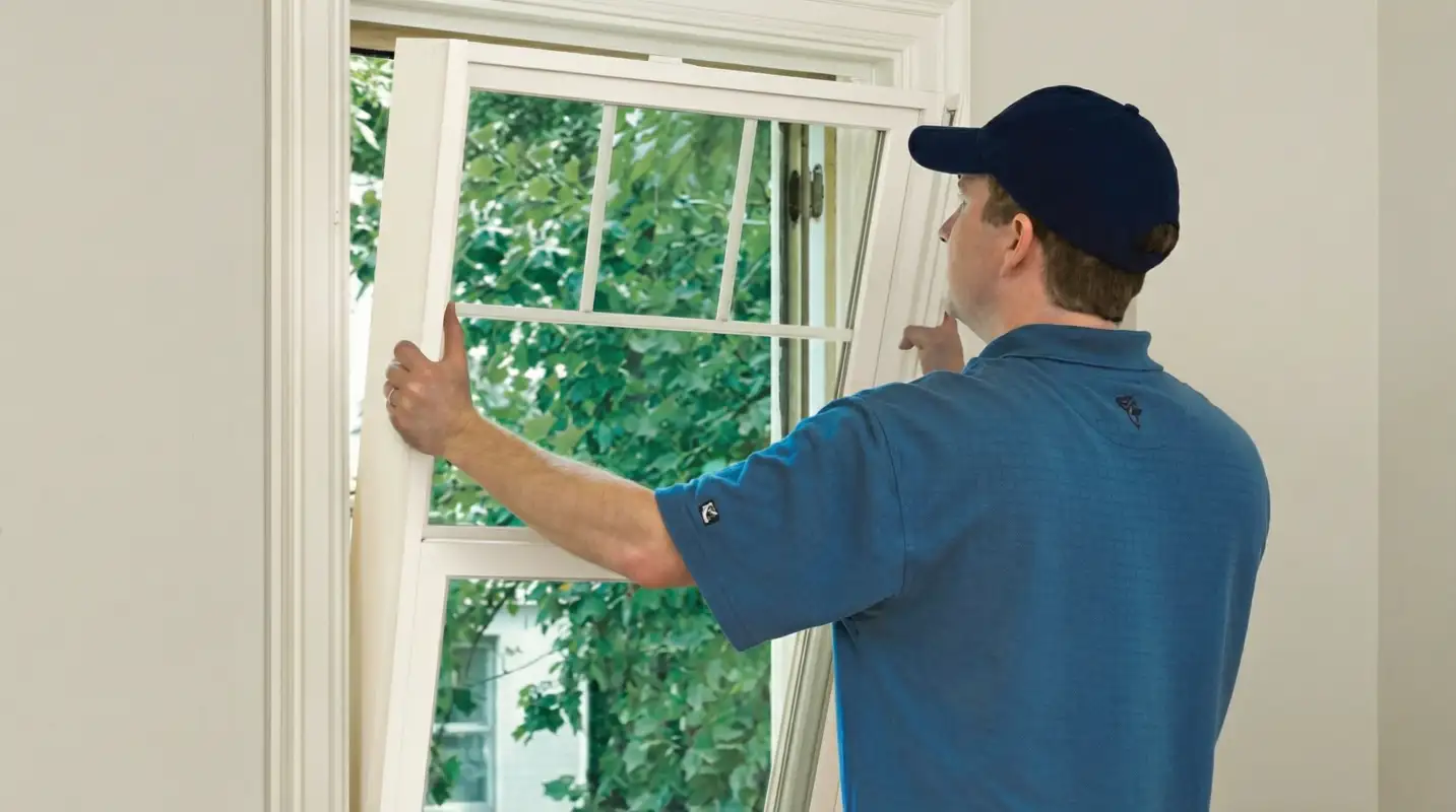 Professional contractors performing a residential window insulation and replacement service in Wichita, KS